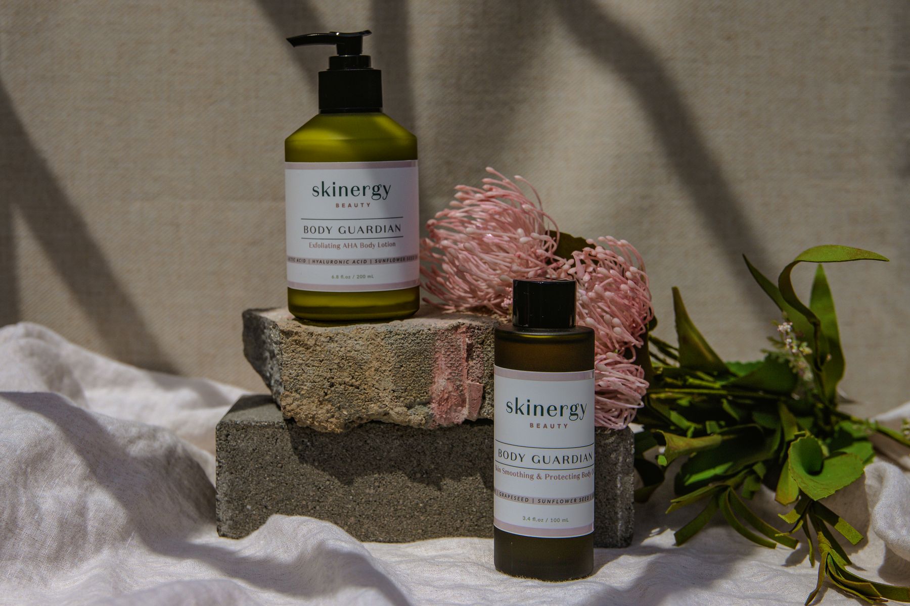 Skincare products arranged on a neutral stone surface