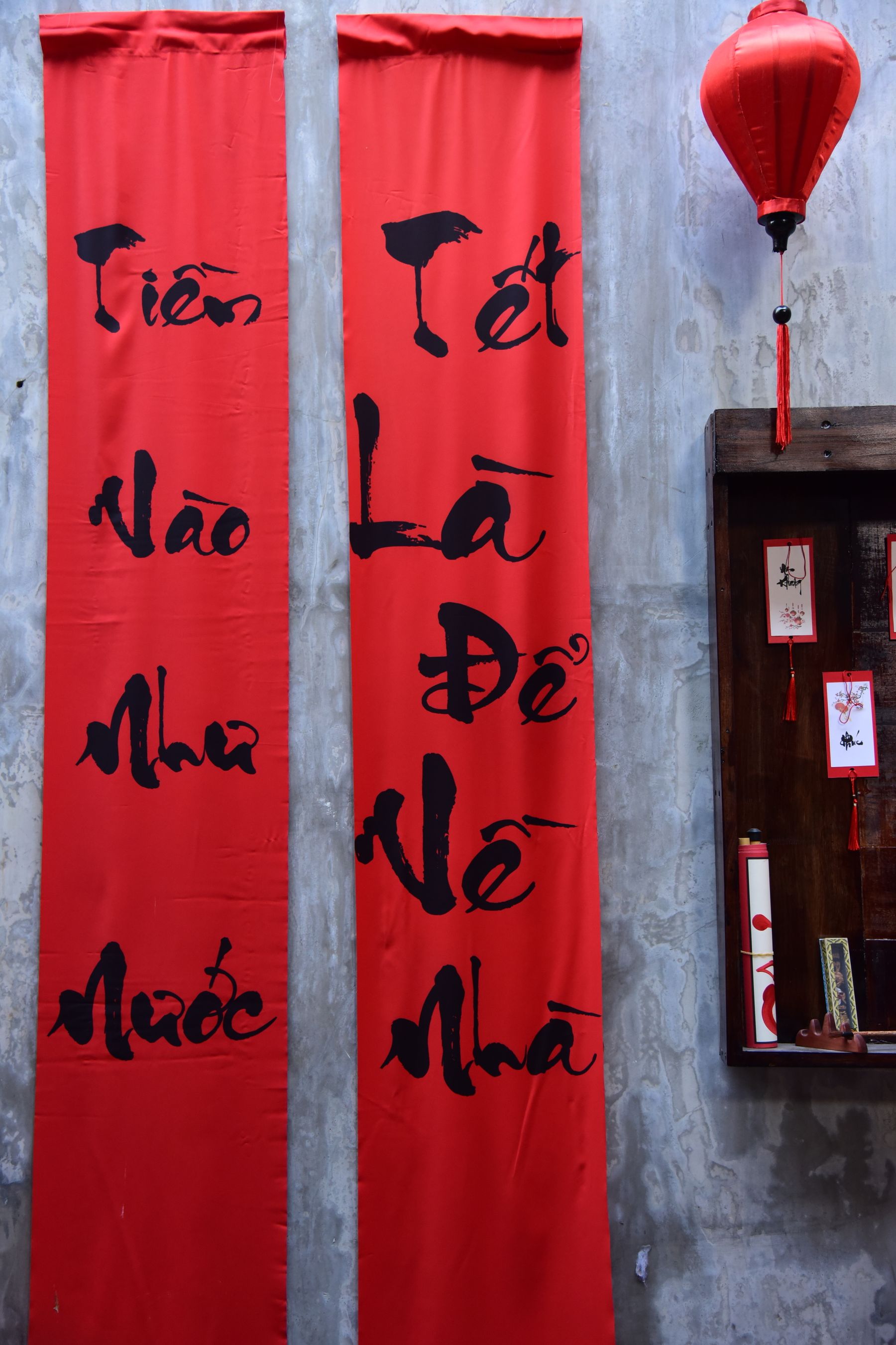 Red Vietnamese New Year banners and a lantern