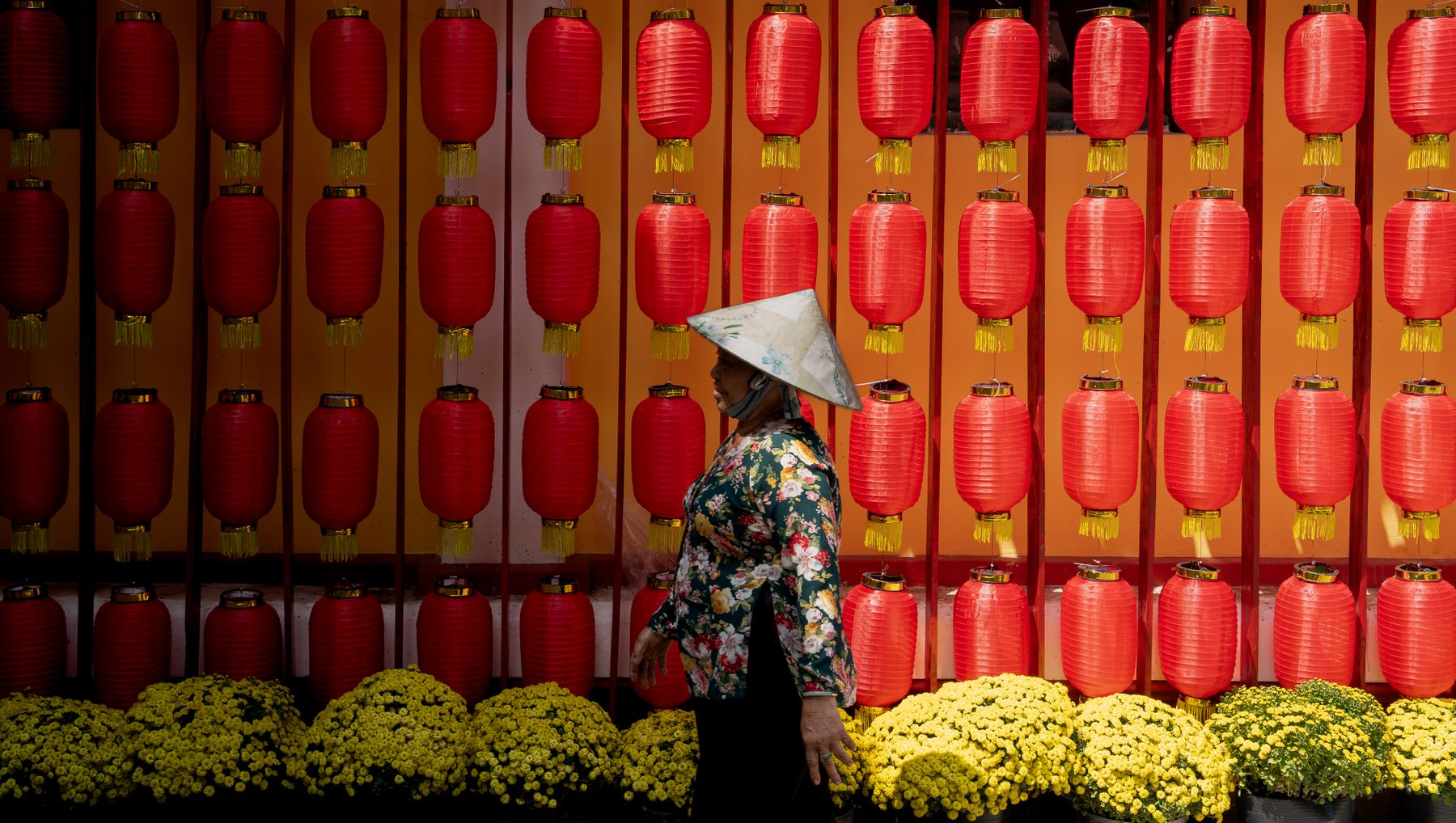 A Vietnamese Tết scene with red lanterns and yellow flowers